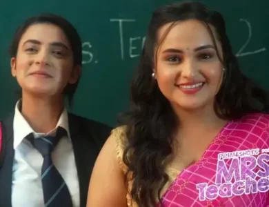 A woman and a girl standing in front of a school writing board