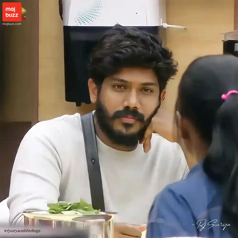 A man (Rj Surya) wearing white shirt and looking at the camera in Bigg Boss Telugu 6 reality show